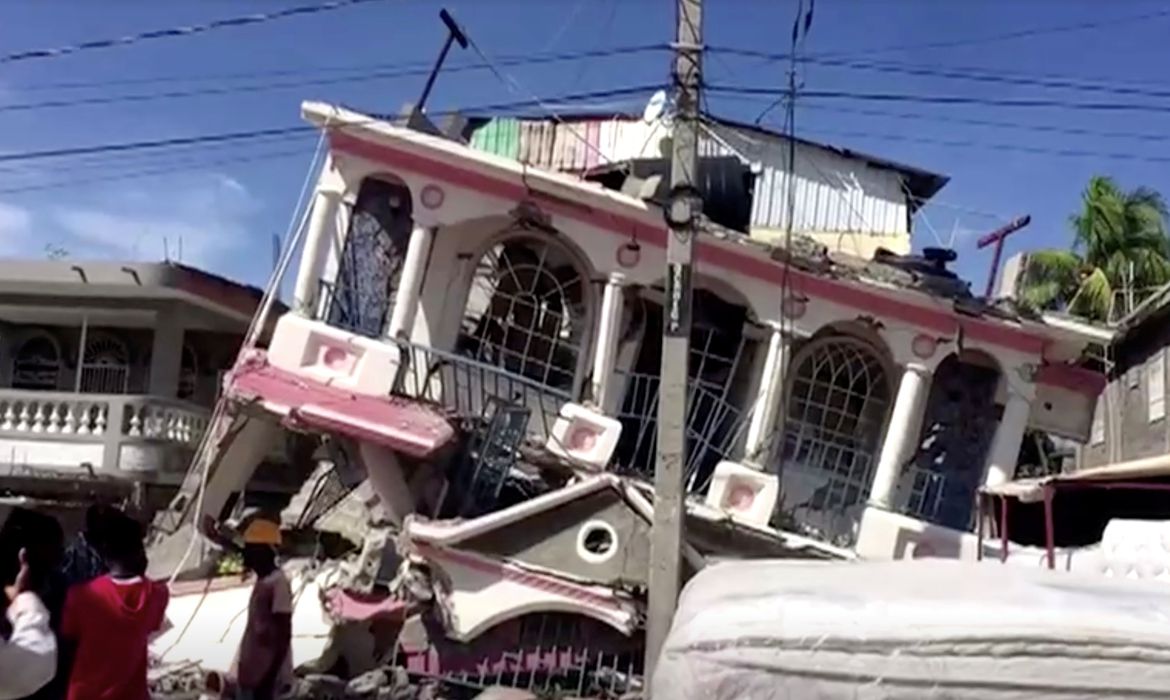 A view of a collapsed building following an earthquake, in Les Cayes, Haiti, in this still image taken from a video obtained by Reuters on August 14, 2021.  REUTERS TV via REUTERS THIS IMAGE HAS BEEN SUPPLIED BY A THIRD PARTY. MANDATORY CREDIT.